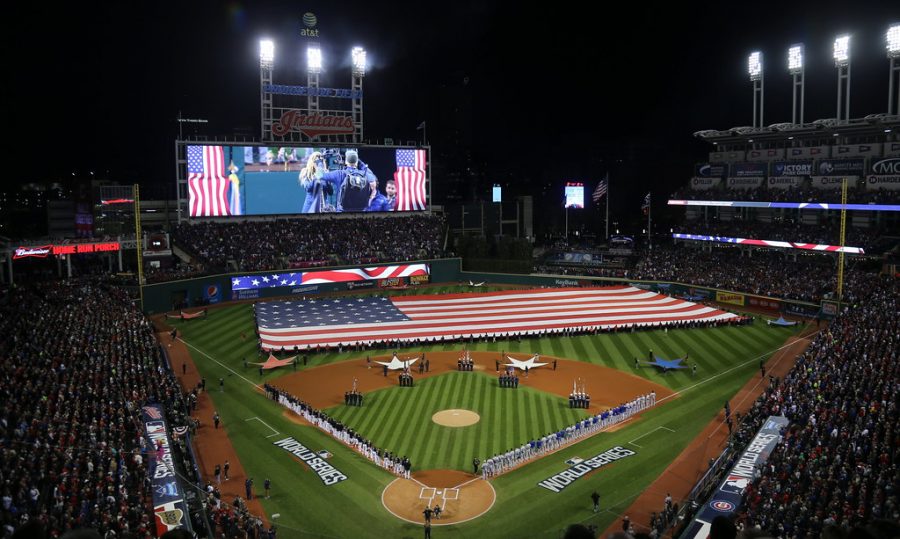 A giant American flag is unfurled before Game 1 of the 2016 World Series at Progressive Field.
