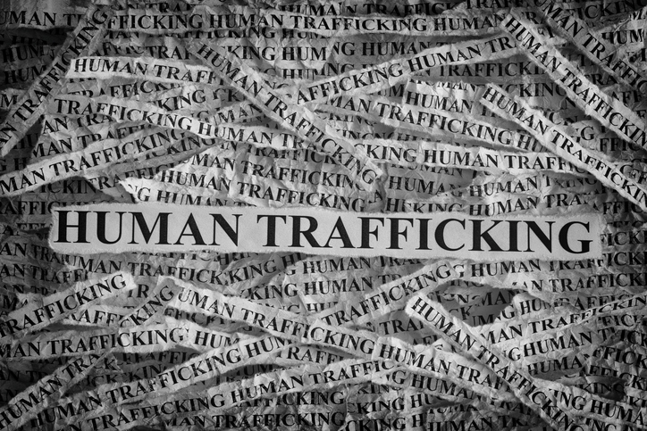 Human Trafficking. Torn pieces of paper with the words Human Trafficking. Concept Image. Black and White. Closeup.