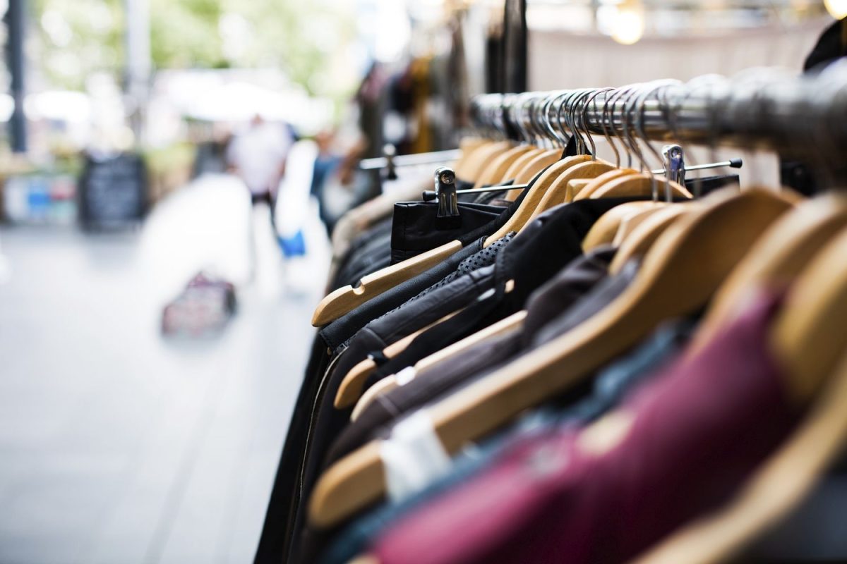 A long row of hangers with clothes in a store in Shoreditch. Original public domain image from Wikimedia Commons